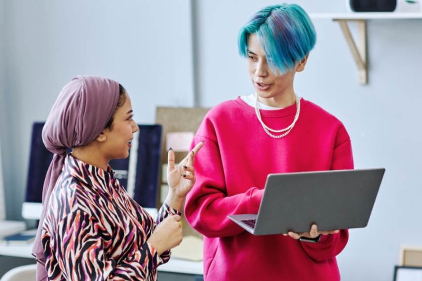 Two people looking at a laptop